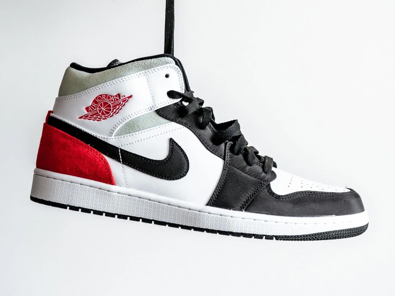 Air Jordan 1 trainer hanging by its laces