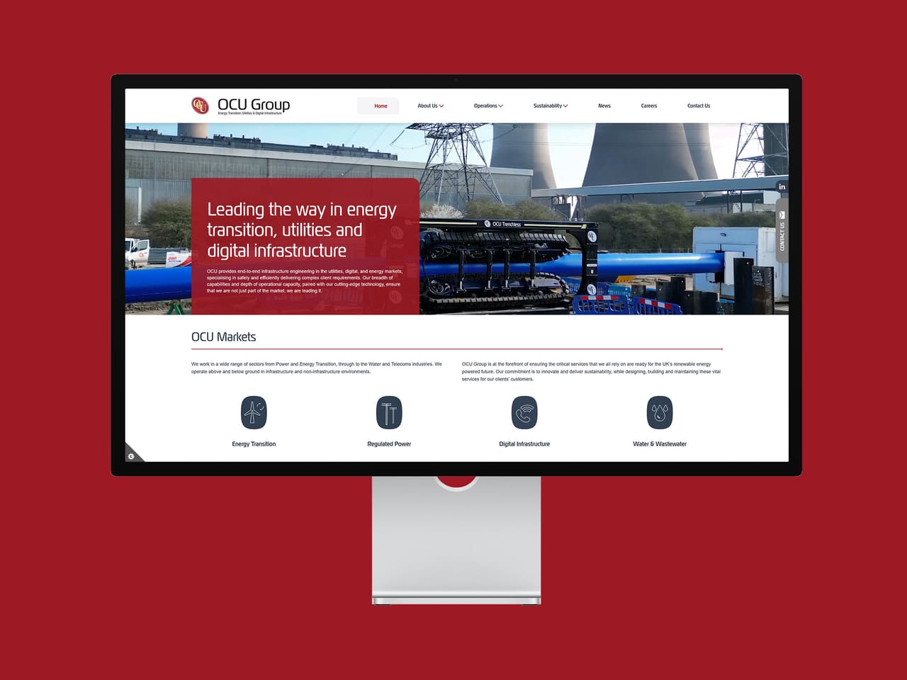 OCU Group homepage on a desktop monitor
